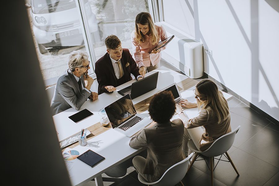 Our Story - View of Group of Employees Working Together in a Modern Office