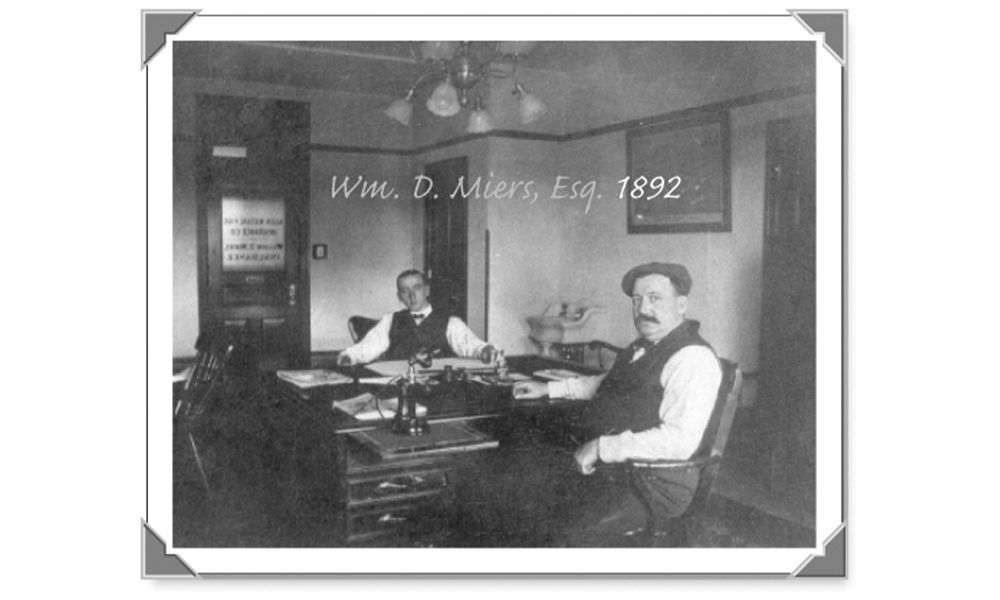 Blog - 1892 Image of the Start of Miers Insurance with the Two Founders Sitting at a Desk