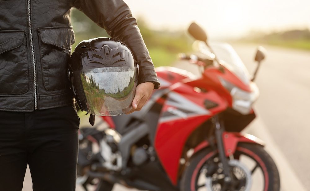May Is Motorcycle Safety Awareness Month - Motorcyclist Holding Helmet