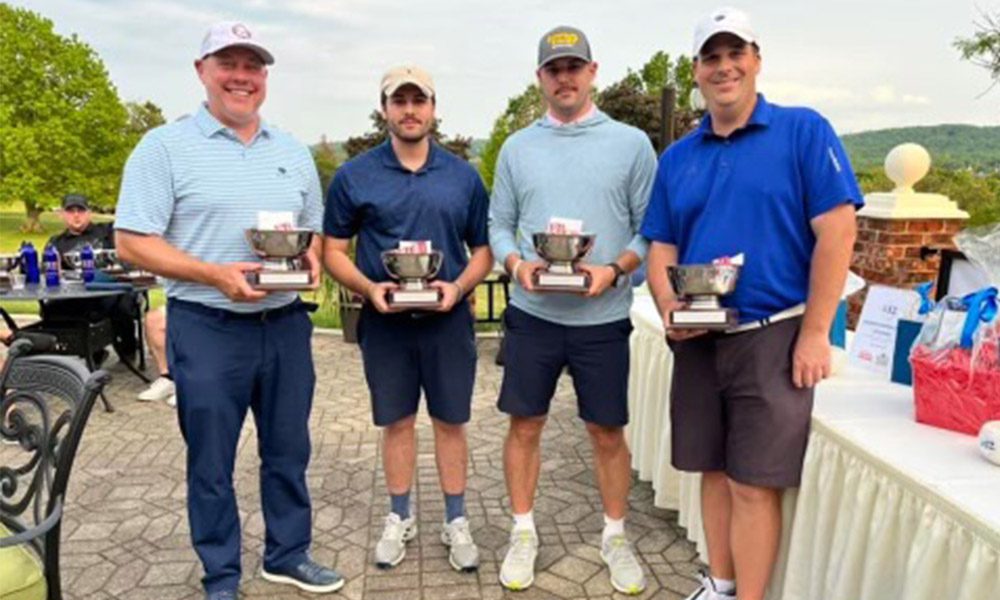 Blog - Miers Insurance Team Smiling and Standing Together Holding Trophies at an Event on a Nice Day