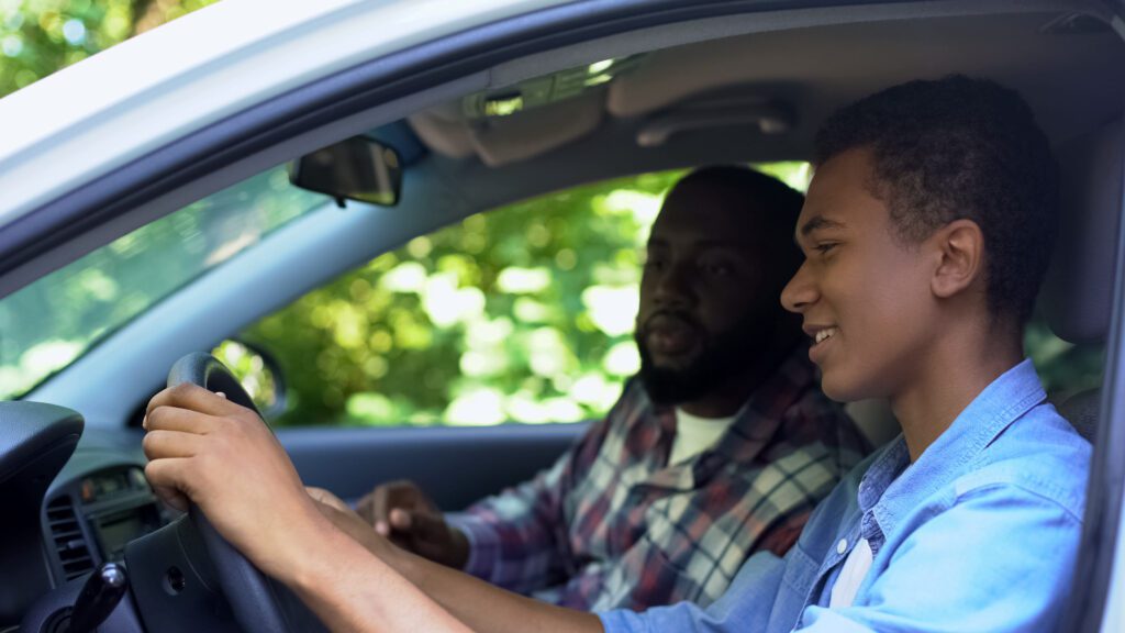 National Teen Driver Safety Week 2023 - Father teaching his son how to drive