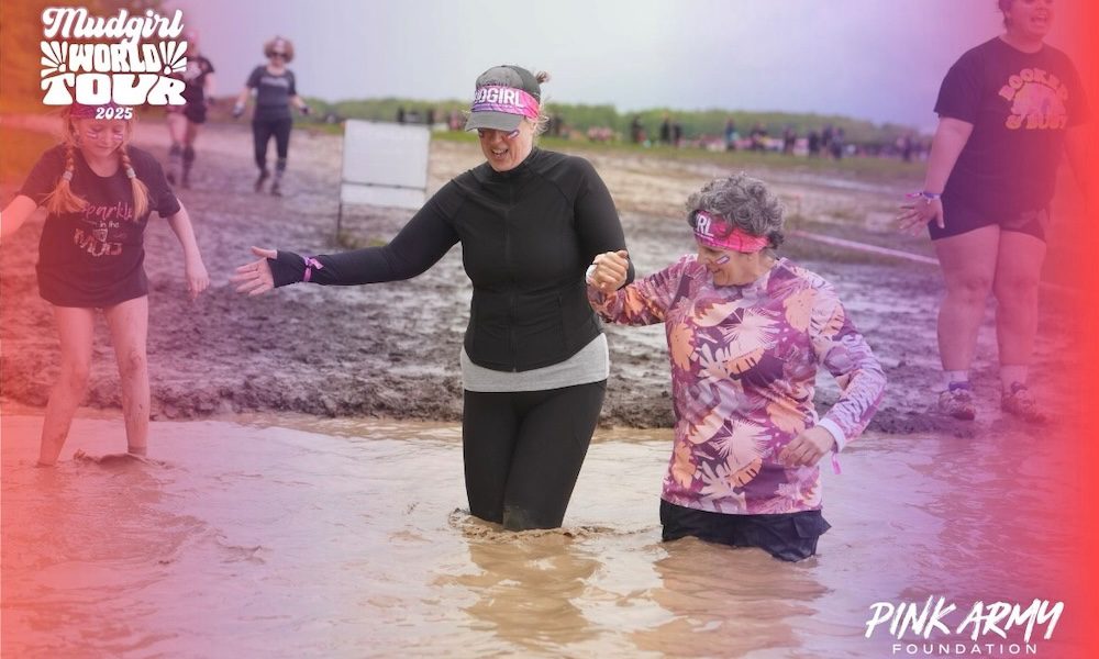 Covered in Mud Fueled by Grit Miers Women Conquer the Mud Girl Run - Joanne and Melissa making their way through the mud pit