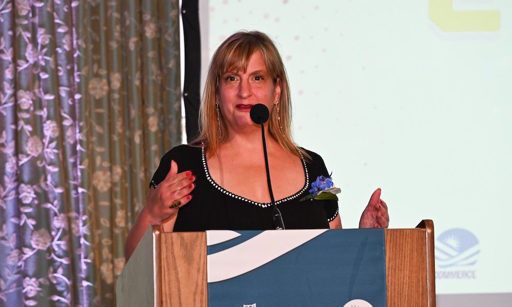 Celebrating Excellence: Congratulations to EZ Micro Solutions! - women speaking at a podium